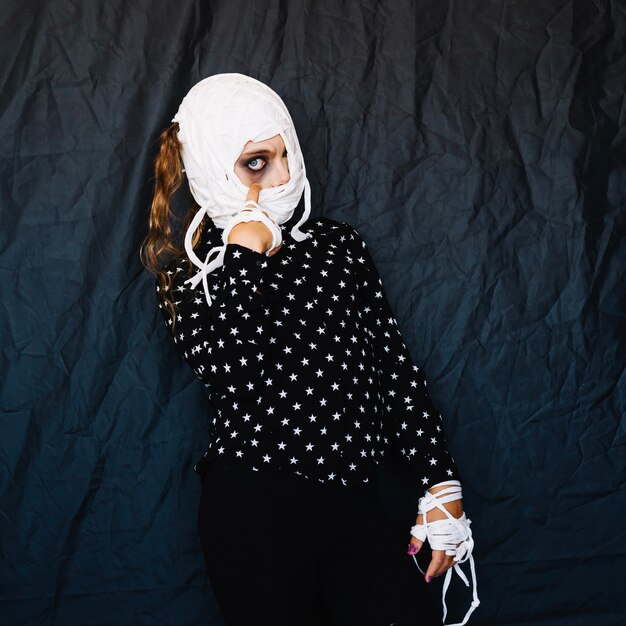 Free Photo woman with bandaged face and hands posing 