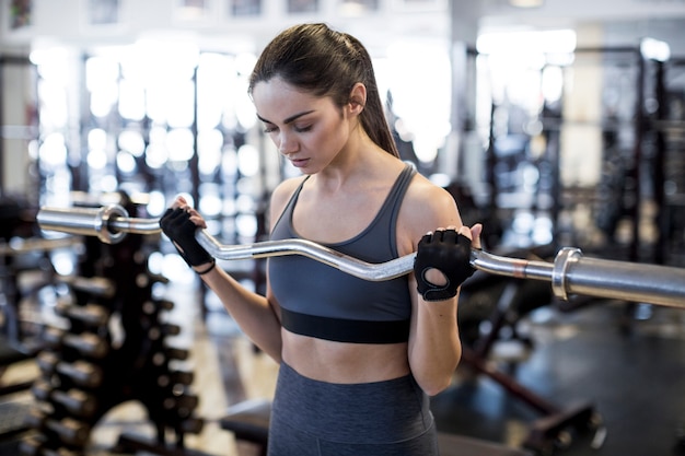 Woman with barbell in gym