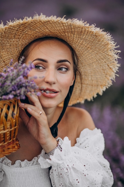 Woman with basket gathering lavander