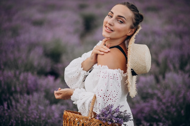 Free photo woman with basket gathering lavander