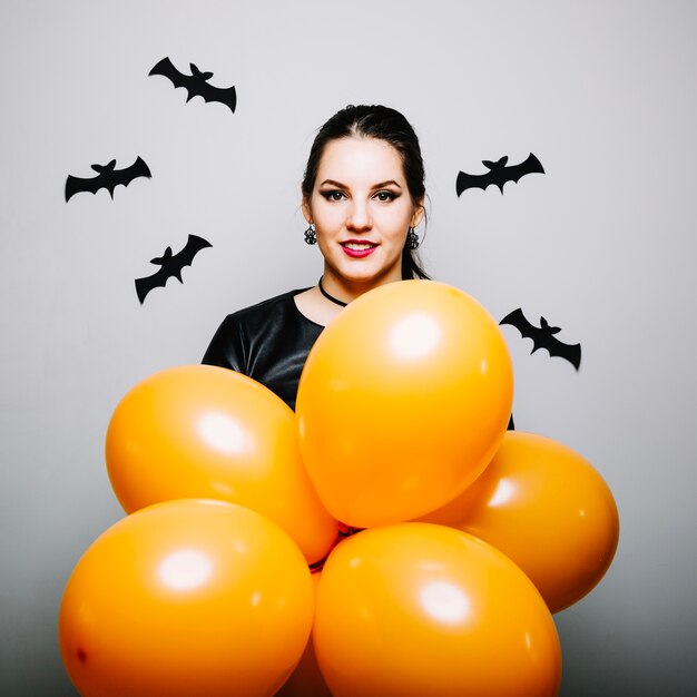 Woman with bats and balloons