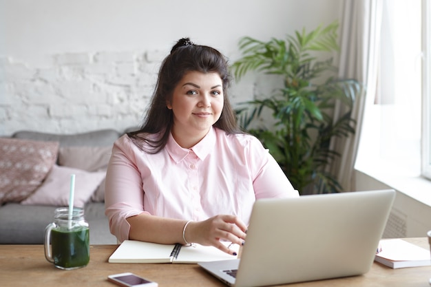 A woman with beautiful body is posing on the couch