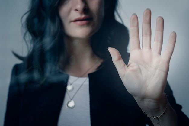 Woman with a beautiful hand touching the window