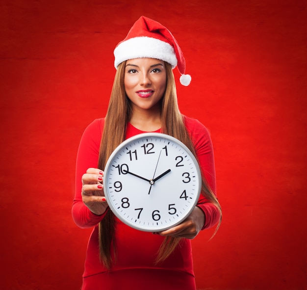 Woman with a big clock in a red background