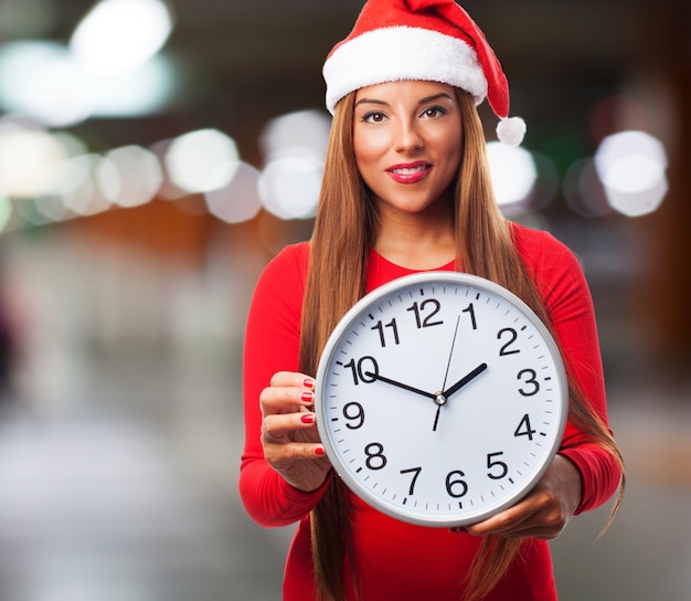 Free photo woman with a big clock