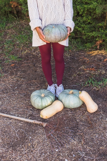 Free photo woman with big vegetables and rake