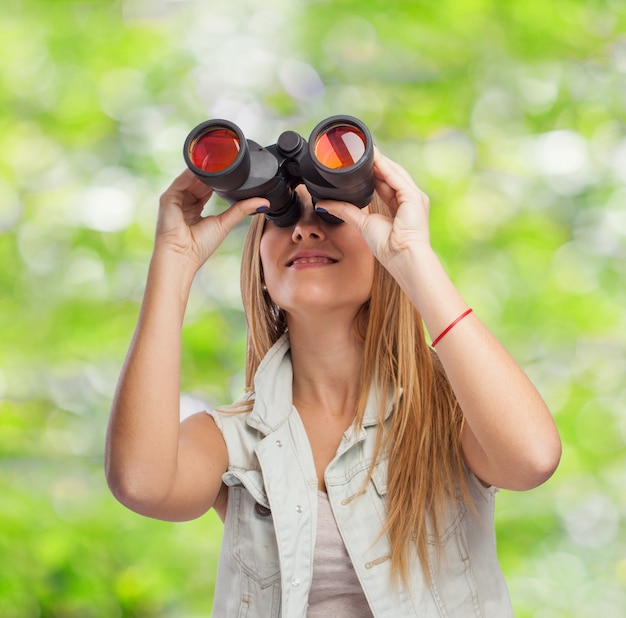 Woman with binoculars in the field