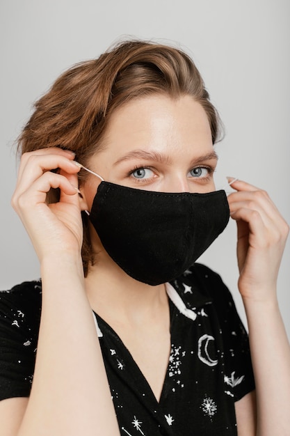 Free Photo woman with black shirt and mask