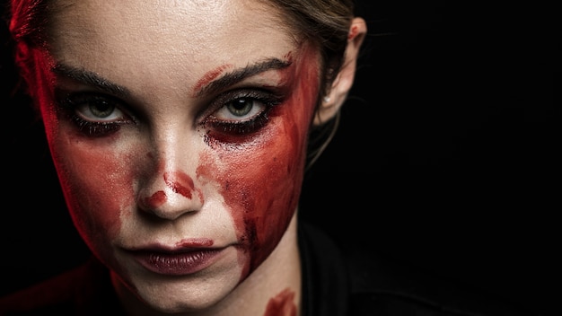 Woman with bloody makeup and copy space