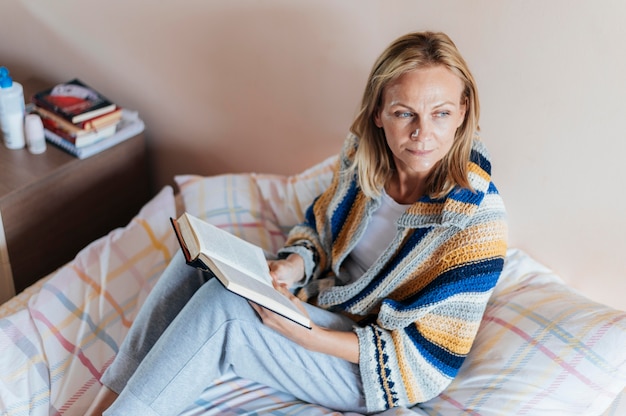 Woman with book in quarantine at home