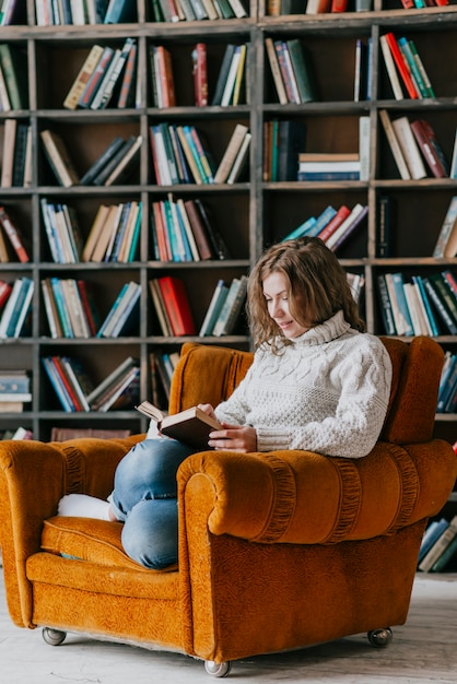 Free photo woman with book resting in sofa