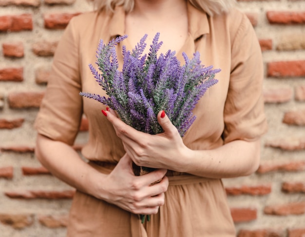 Free photo woman with bouquet of lavender flowers