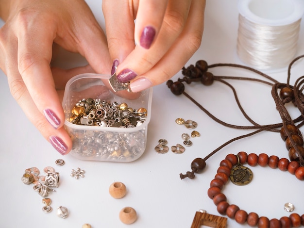 Free Photo woman with box of metallic accessories