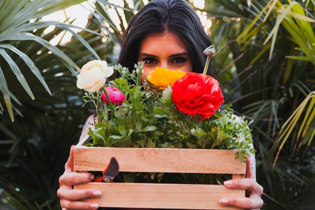 Free photo woman with box with flowers