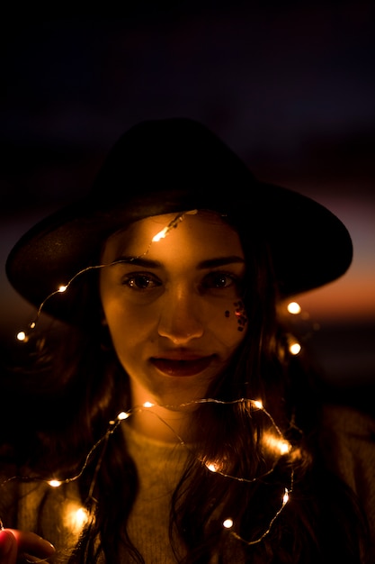 Free photo woman with burning garland on head