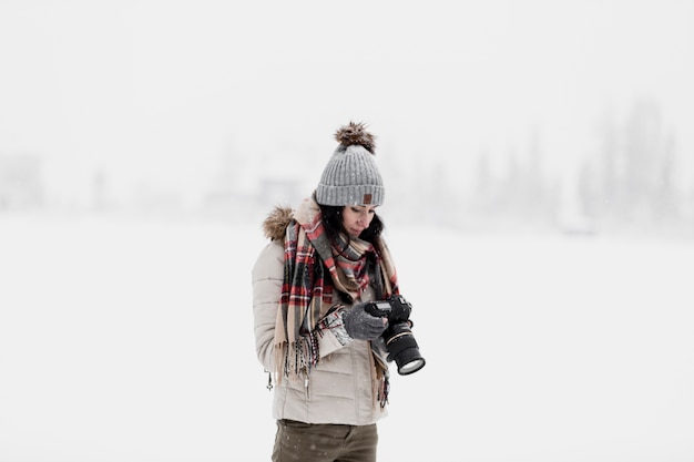 Free photo woman with camera in winter