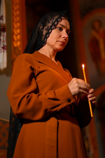 Free photo woman with candle at the church