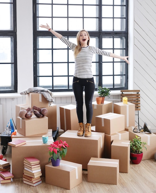 Free Photo woman with cargo packages ready to shipping or moving, standing and laughing