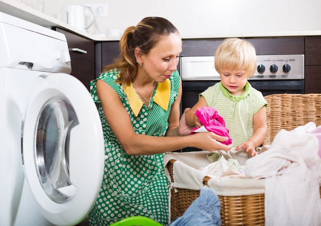 Woman with child near washing machine