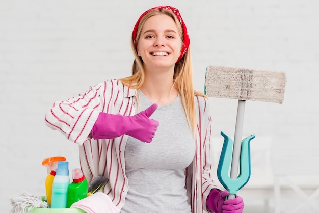 Free photo woman with cleaning products showing ok sign