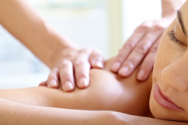 Woman with closed eyes enjoying the massage