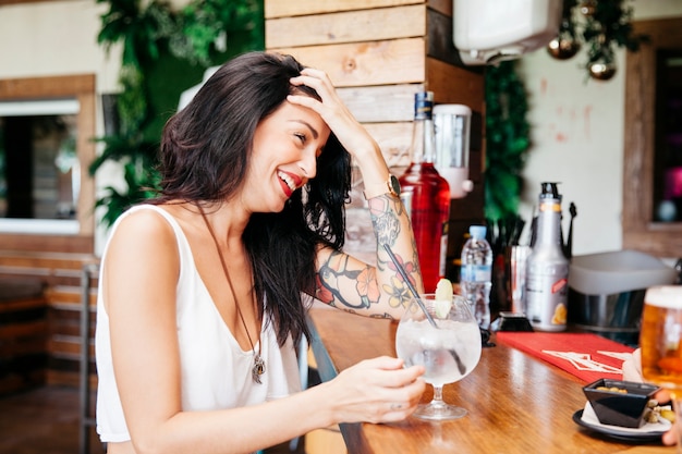 Woman with cocktail at bar