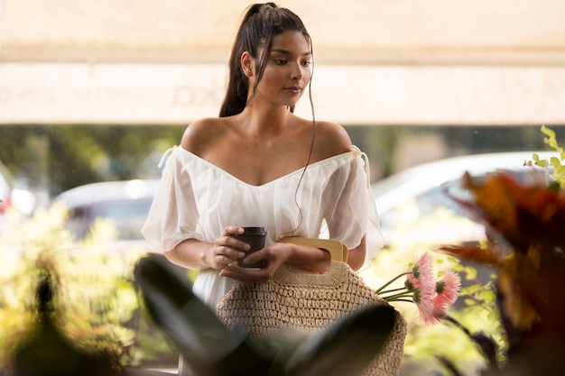 Free Photo woman with coffee cup front view