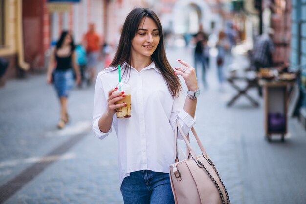 Woman with coffee in a street