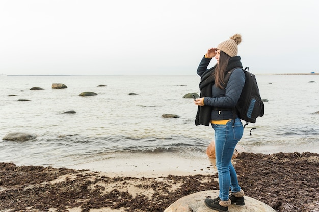 Free photo woman with compass looking at distance