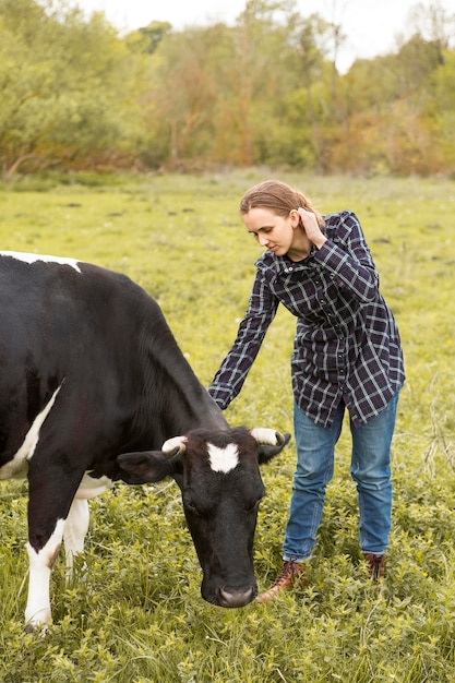 Woman with a cow at farm