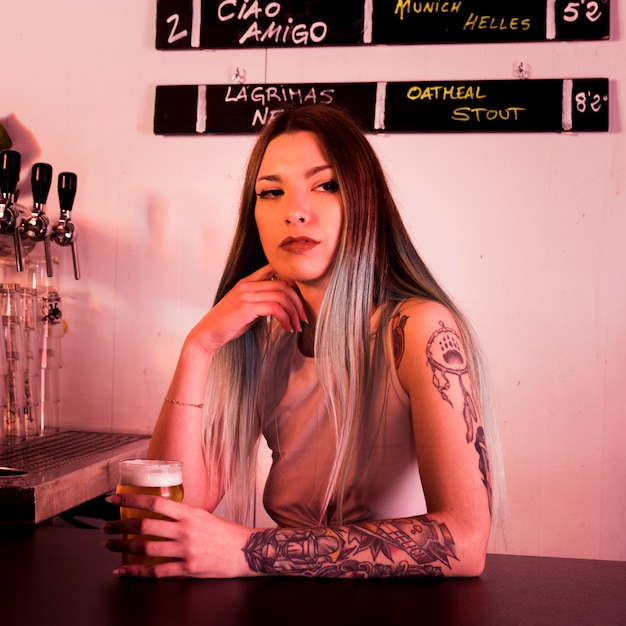 Woman with craft beer in bar