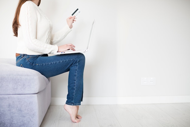 Woman with credit card and laptop