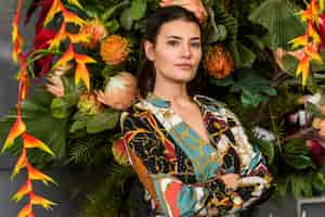 Free photo woman with crossed arms standing in green house