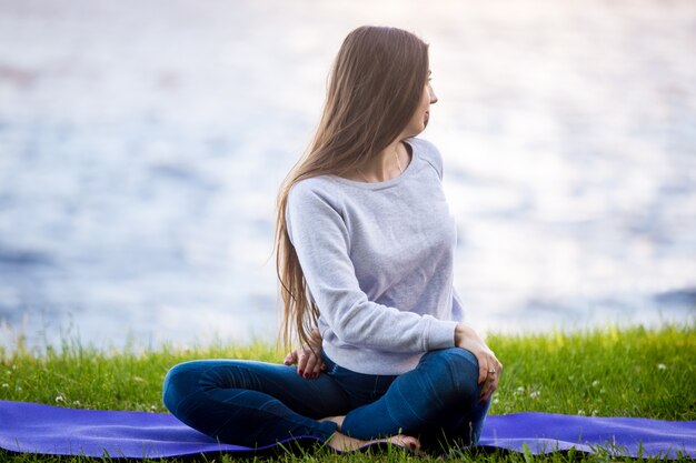 Woman with crossed legs sitting in a park