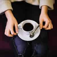 Free photo woman with cup of drink on plate