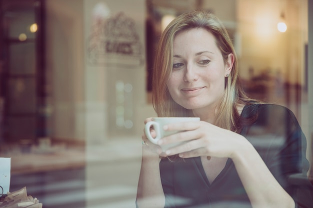 Woman with cup of hot beverage