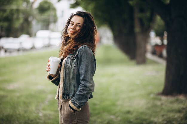 Woman with curly hair drinking coffee