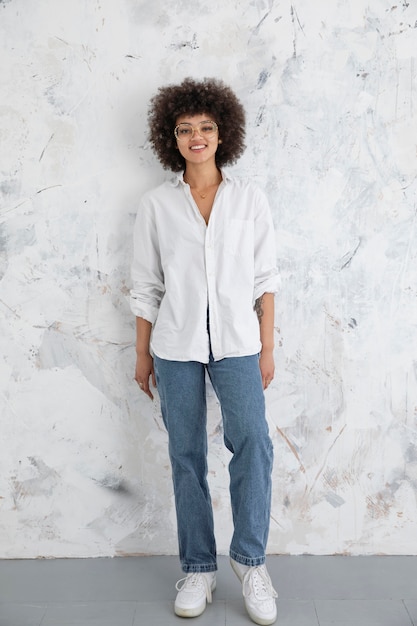 Free Photo woman with curly hair posing in a confident way