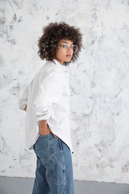 Free Photo woman with curly hair posing in a confident way