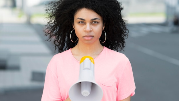 Woman with curly hair protesting front view