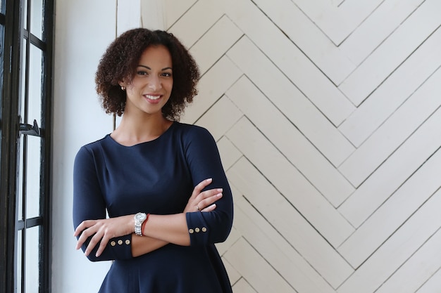 Woman with curly hair and smiling