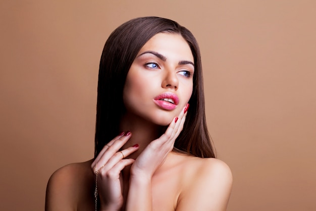 Woman with dark straight hair and sexy lips posing