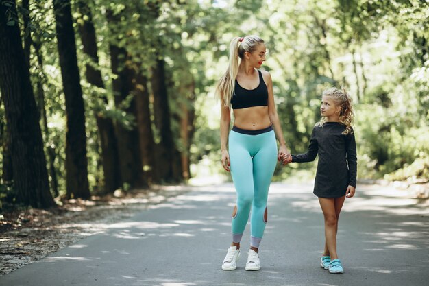 Woman with daughter jogging in park