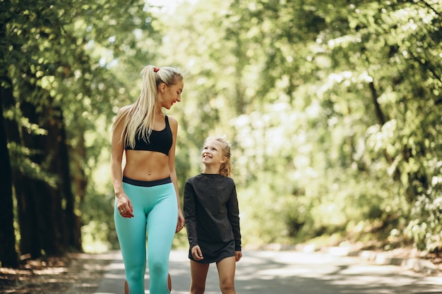 Free photo woman with daughter jogging in park