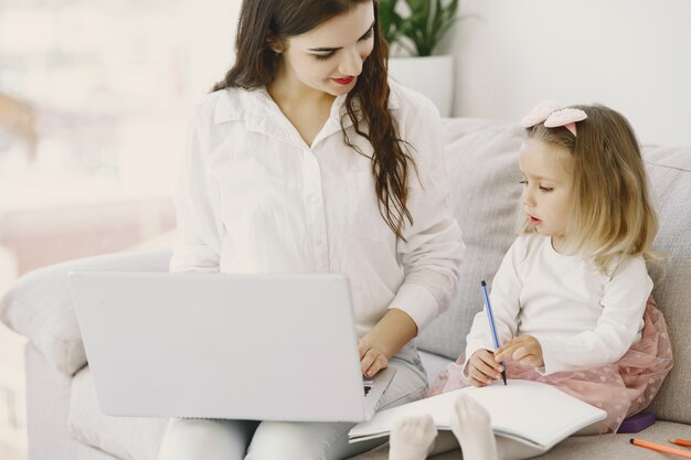 Woman with daughter using laptop computer