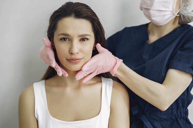 Woman with a doctor in cosmetology studio