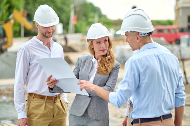 Free Photo woman with document looking questioningly at man