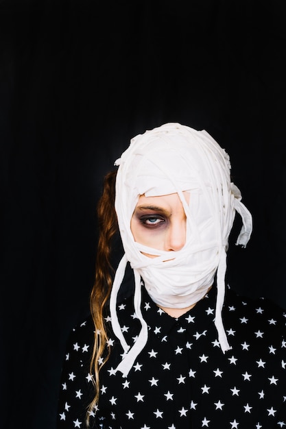 Free photo woman with eye half-closed and bandages