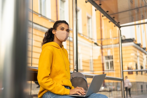 Free photo woman with face mask and social distance concept