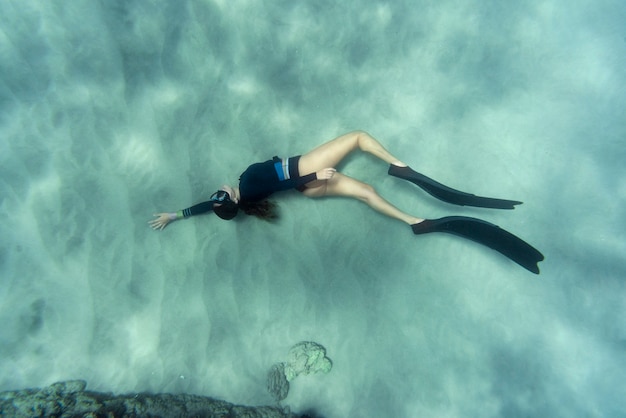 Free photo woman with flippers swimming in the ocean